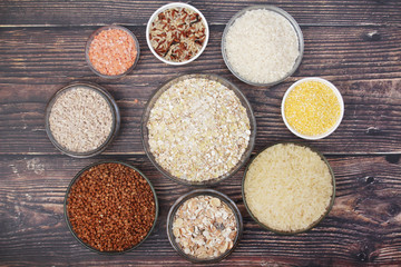 A set of bowls filled with different seeds: buckwheat, rise, corn and oatmeal