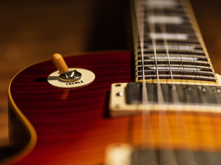 electric guitar body close-up view is on the wood floor