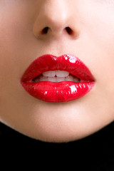 Closeup beautiful female lips with red lipstick.