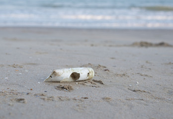 Plastic package debris on the sand beach