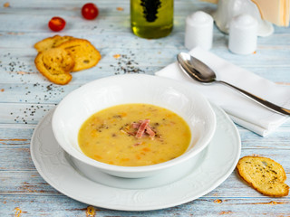 Pea soup with ham. Restaurant serving.