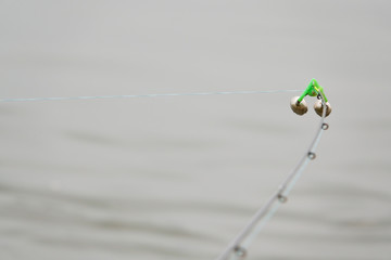 Fishing bell at the end of a fishing rod. Bells will ring when the fish is hooked.