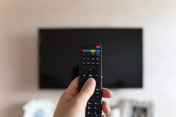 TV remote controller in hand of man