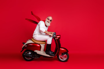 Crazy aged santa man coming newyear 2020 party by vintage moped wear jumper and trousers isolated...
