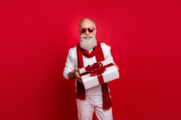 Cool aged santa like man came 2020 party with big giftbox wear sun specs knitted jumper isolated...