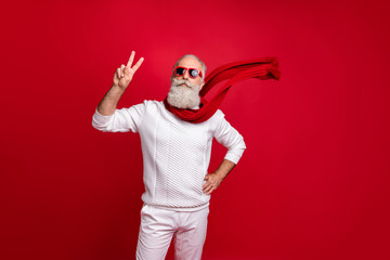 Fototapeta na wymiar Trendy well-dressed santa character style showing v-sign wear sun specs knitted clothes isolated red background