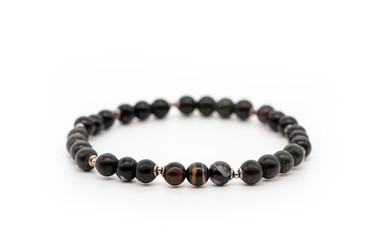 Bracelet from black and Madagascar agate on a white background. Natural stone jewelry.
