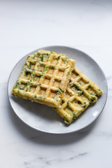 spinach waffles on white marble background with opy space