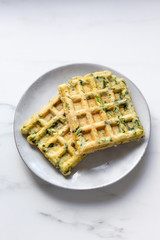 spinach waffles on white marble background with opy space