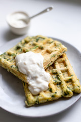 spinach waffles on white marble background with opy space