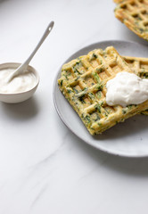 spinach waffles on white marble background with opy space