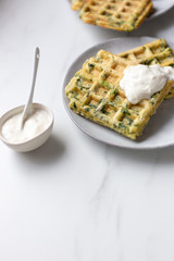 spinach waffles on white marble background with opy space