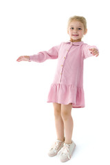 A little girl is photographed in the studio on a cyclorame.