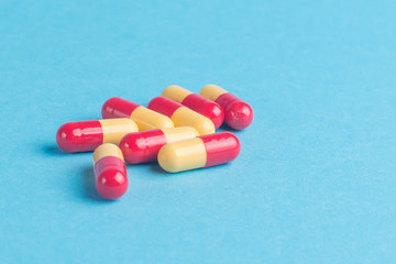 Mix of medicines, pills, on a blue background.