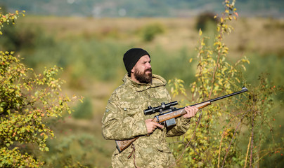 Hunting masculine hobby. Man brutal gamekeeper nature background. Hunter hold rifle. Bearded hunter spend leisure hunting. Focus and concentration of experienced hunter. Hunting and trapping seasons