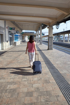 woman walking in a train station