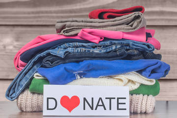 Donation concept. Donation box with donation clothes on a  Charity. Helping poor and needy people.