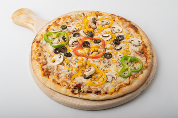 Delicious Vegetarian pizza served on wooden plate isolated on white.