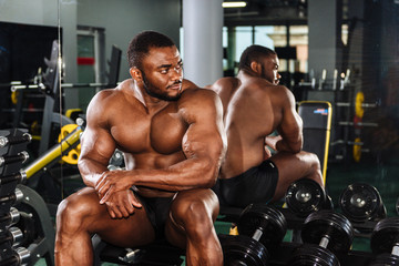 Fototapeta na wymiar Male athlete, bodybuilder, working out in the gym