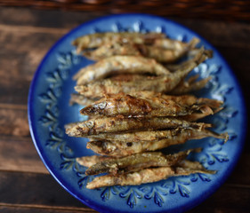fried fish with crispy crust on a blue plate