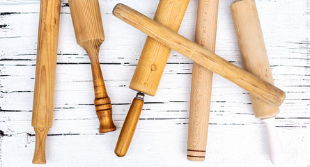 Vintage old kitchen utensils on a white wooden background.