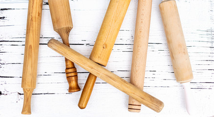 Vintage old kitchen utensils on a white wooden background.