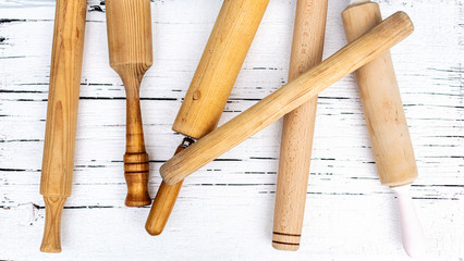 Vintage old kitchen utensils on a white wooden background.