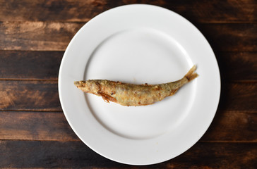 fried battered fish on wooden table top view