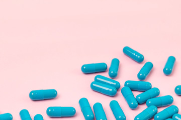 Blue pills at pink background. Empty place for text