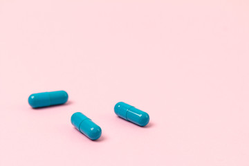 Blue pills at pink background. Empty place for text
