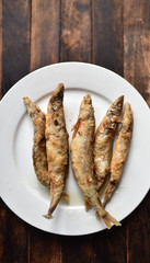 fried battered fish on wooden table top view
