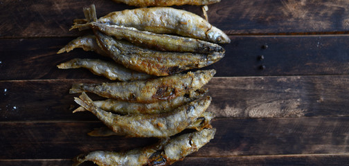 fried battered fish on wooden table top view