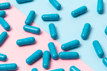 Blue pills on pink background. Template for feminine beauty blog social media