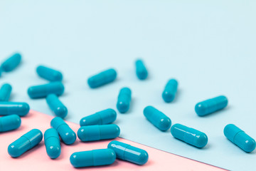Blue pills on pink background. Template for feminine beauty blog social media