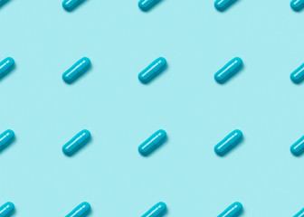 Seamless pattern with blue pills on blue background.