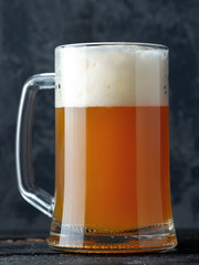 Mug of wheat beer close-up on a dark background
