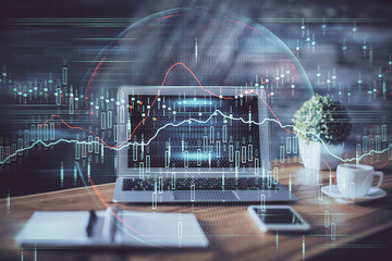 Double exposure of graph and financial info and work space with computer background. Concept of international online trading.