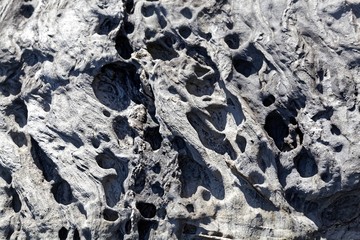 Surface of a weathered grey metamorphic rock.