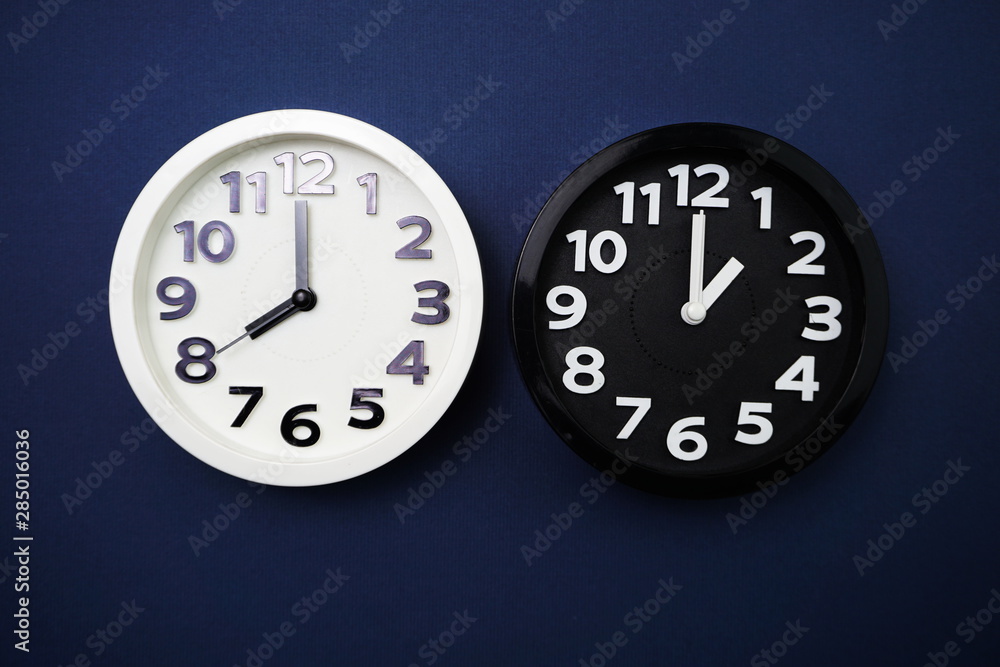Poster top view of alarm clocks with different time flat lay composition