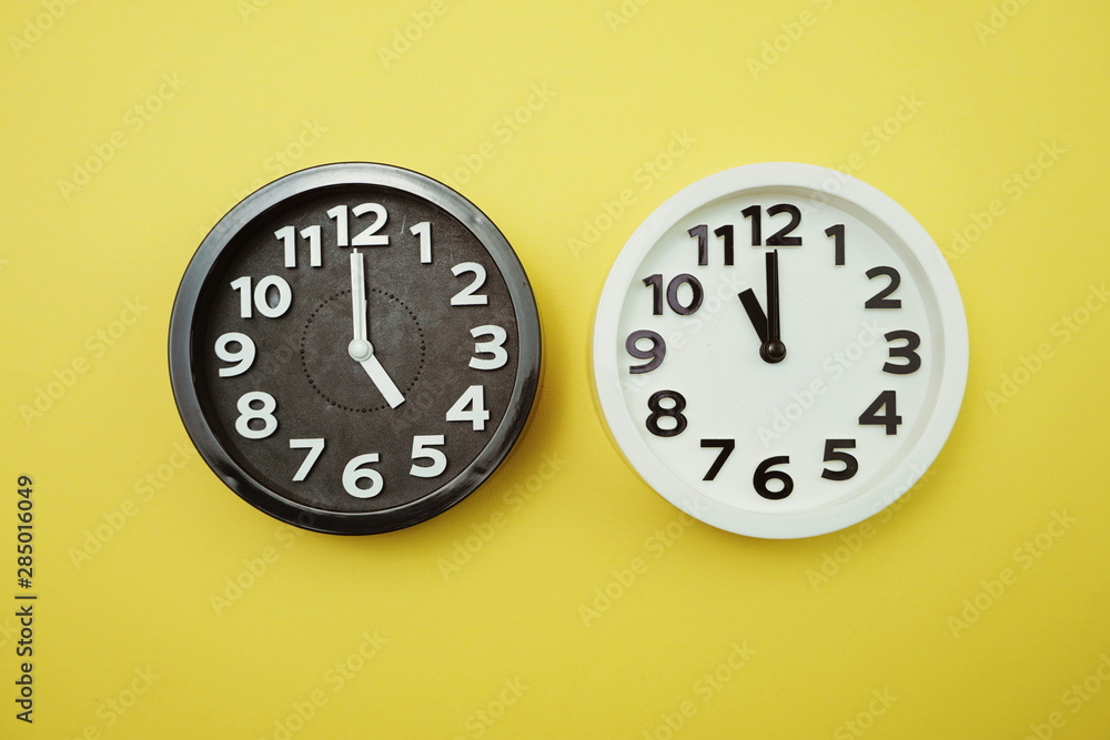 Poster top view of alarm clocks with different time flat lay composition
