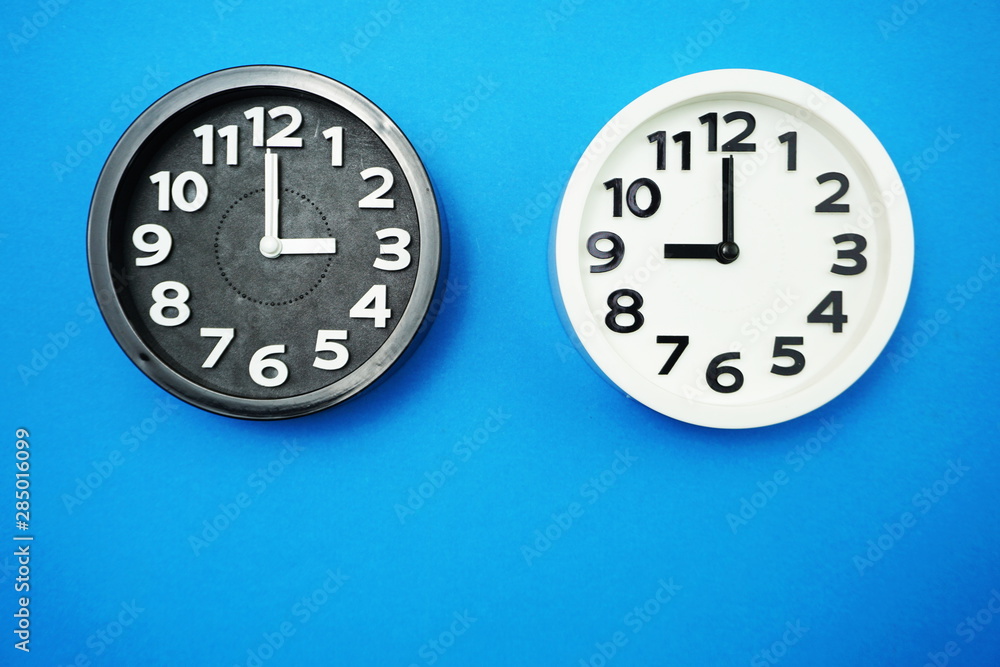 Poster top view of alarm clocks with different time flat lay composition