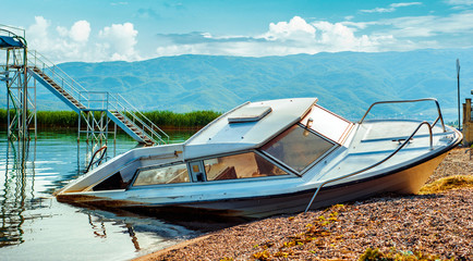 North macedonia. Ohrid. Old broken boat on stone shore