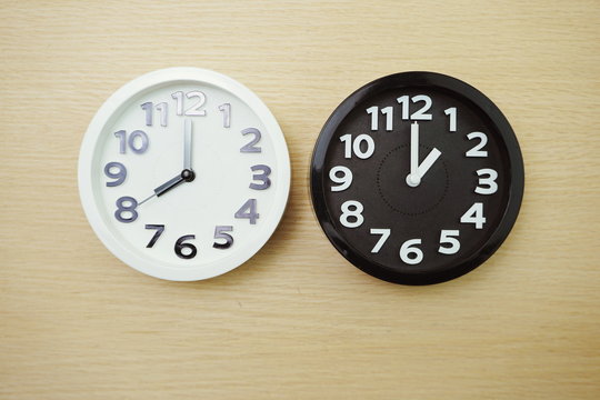 Top view of alarm clocks with different time Flat lay composition