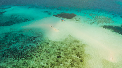 Sand bar among coral reefs in turquoise atoll water, top view. Summer and travel vacation concept. Balabac, Palawan, Philippines.