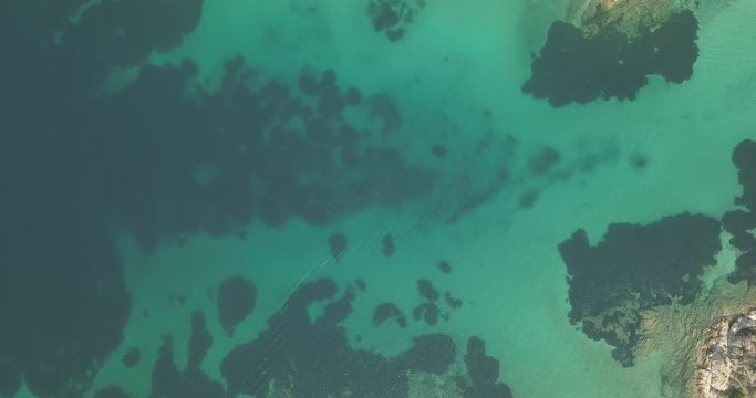 Halkidiki, Greece : boats and yachts moored near the private island  in a secluded location on the Aegean sea. View from drone