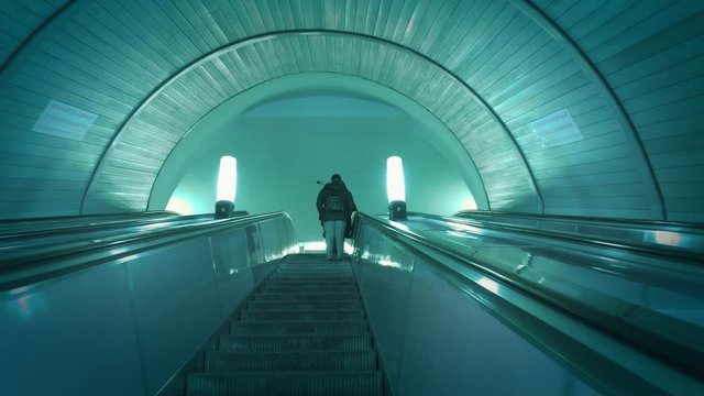 People moving up in escalator in subway metro station. Slow motion, 4K UHD.