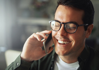 Man smiling while talking on the mobile phone