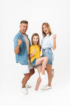 Full length photo of happy caucasian family woman and man with little girl laughing and celebrating success