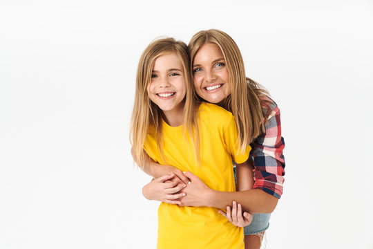 Photo of young caucasian family mother and daughter smiling and hugging together at camera