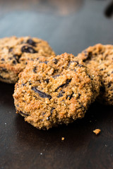 Paleo Chocolate Chip Cookies Made with Coconut and Almond Flour on Dark Wooden Board.